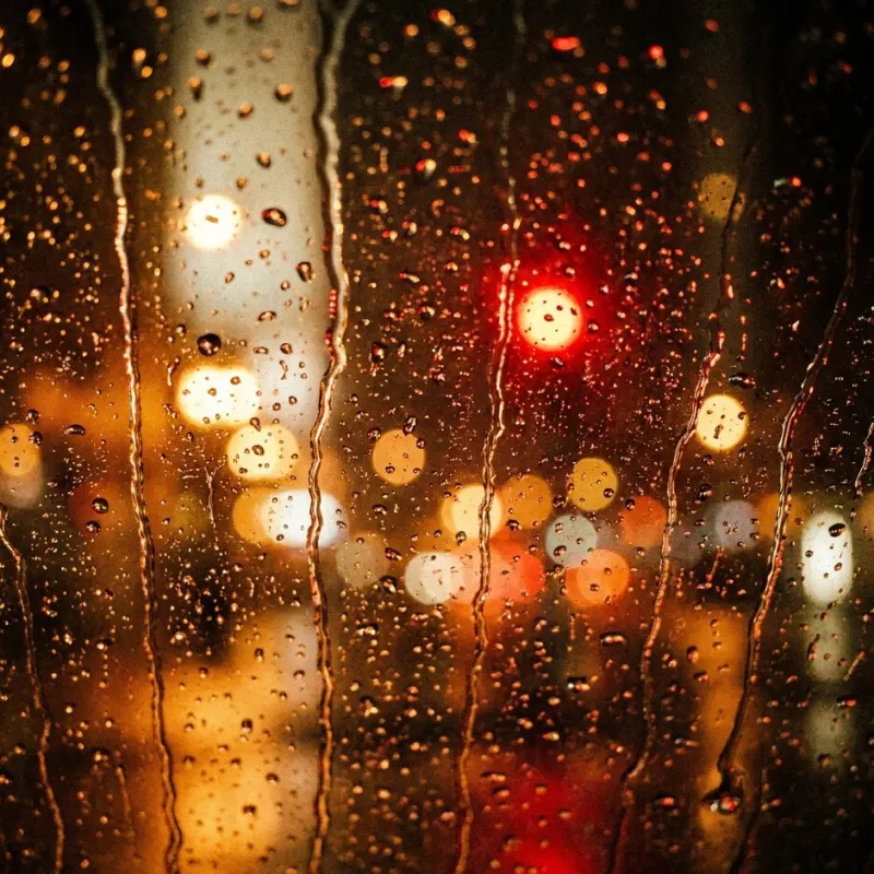 A siren echoing through wet city streets
